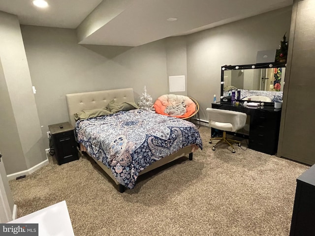 bedroom with carpet floors and a baseboard radiator