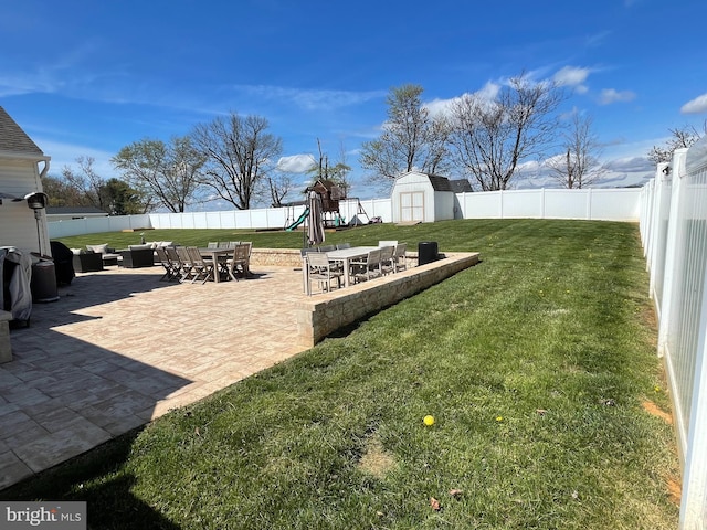 view of yard with a playground, a patio area, outdoor lounge area, and a storage unit