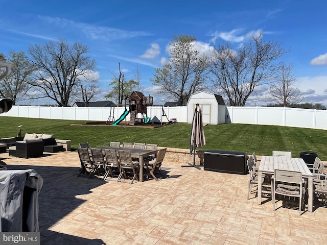 view of patio / terrace featuring a storage unit, a playground, and an outdoor hangout area