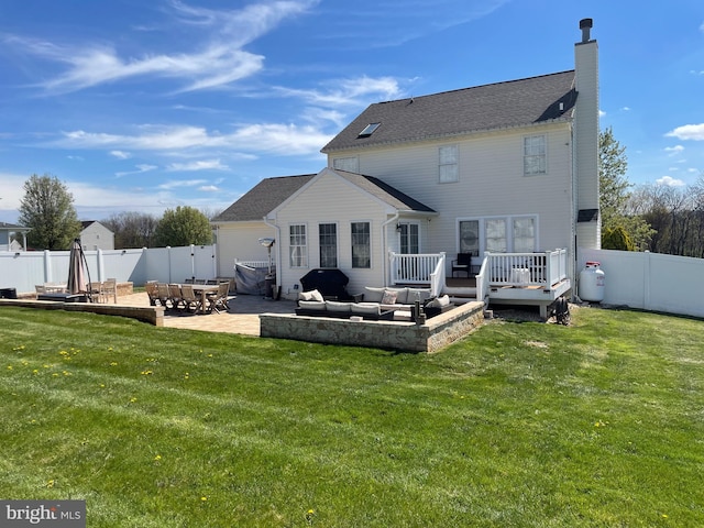 rear view of property with a deck, an outdoor hangout area, a patio, and a yard