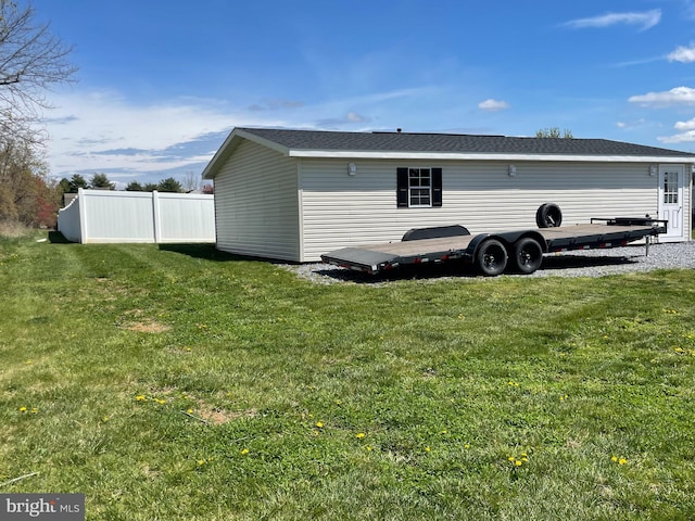 rear view of property featuring a lawn