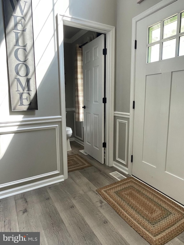 entryway with hardwood / wood-style floors