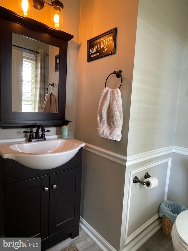 bathroom featuring vanity and toilet