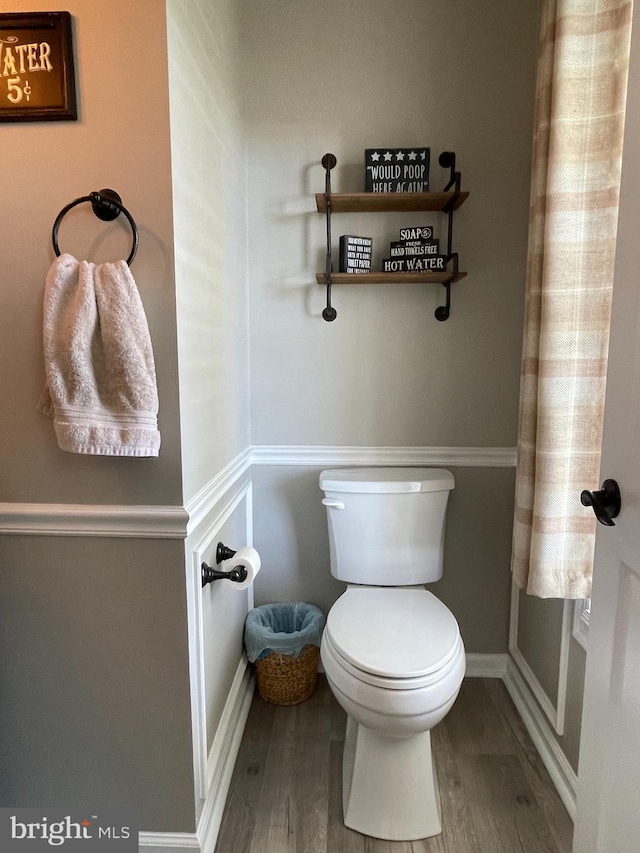 bathroom with hardwood / wood-style flooring and toilet