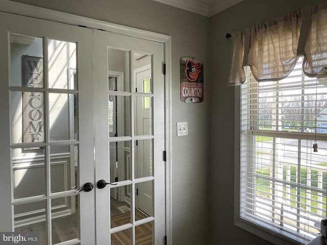 doorway with crown molding and french doors