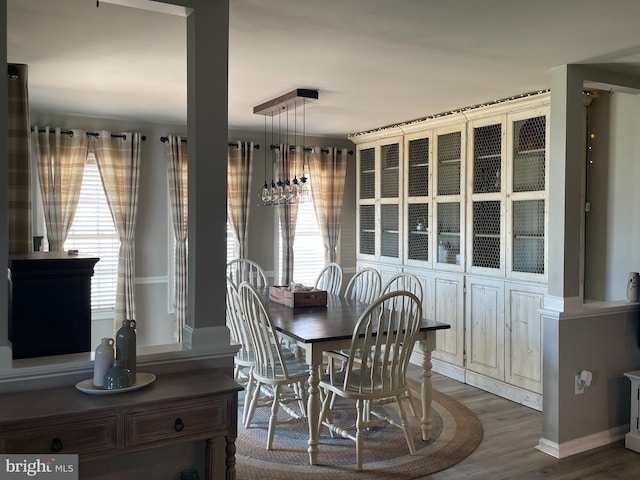 dining room with wood-type flooring and a wealth of natural light