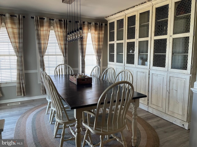 dining space with a healthy amount of sunlight and dark wood-type flooring