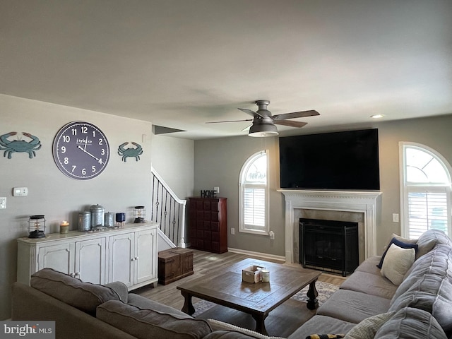 living room featuring ceiling fan and light hardwood / wood-style flooring