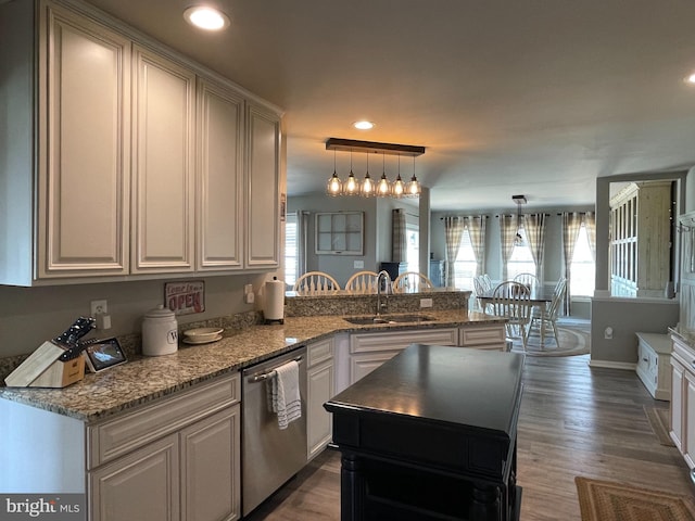 kitchen with dishwasher, sink, hanging light fixtures, dark hardwood / wood-style floors, and kitchen peninsula