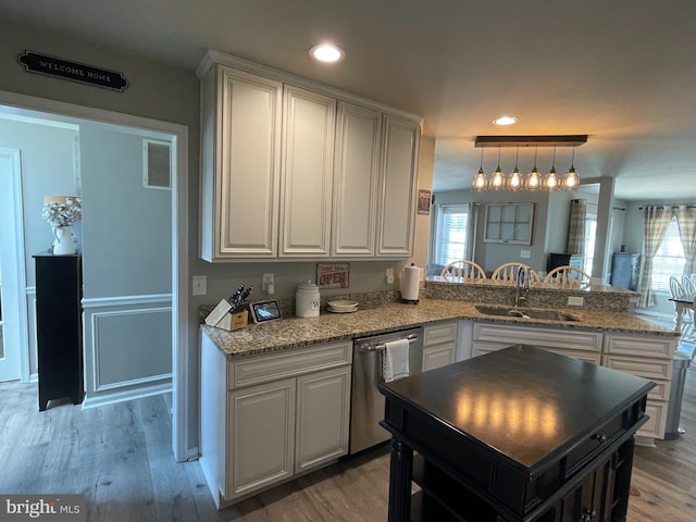 kitchen featuring a wealth of natural light, dishwasher, wood-type flooring, and sink