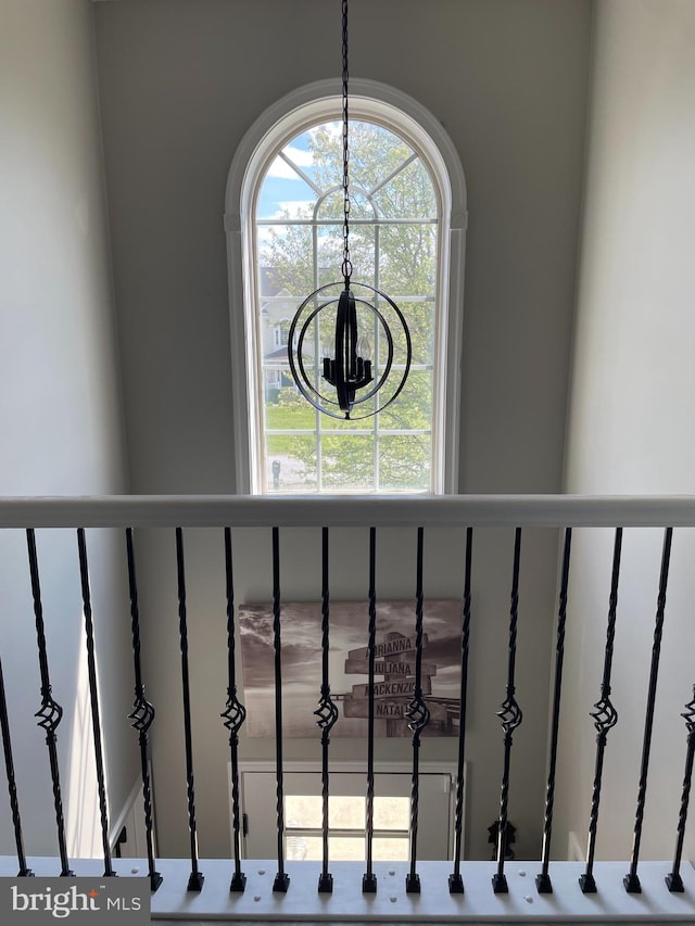 stairway with a chandelier