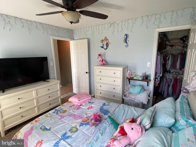 bedroom featuring a walk in closet, ceiling fan, and a closet