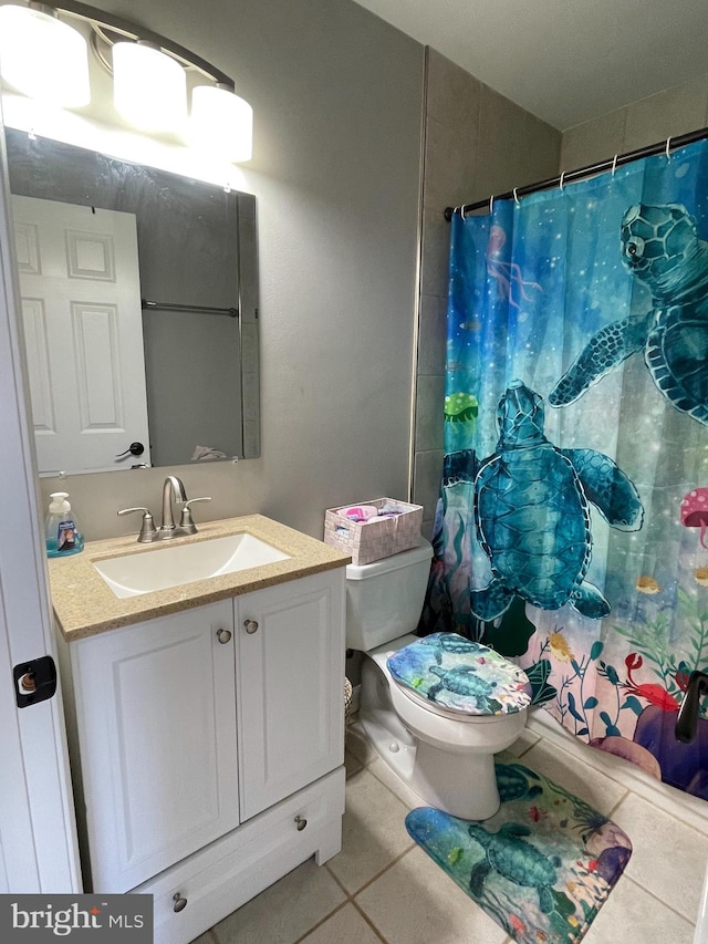 bathroom with tile patterned flooring, vanity, toilet, and a shower with curtain