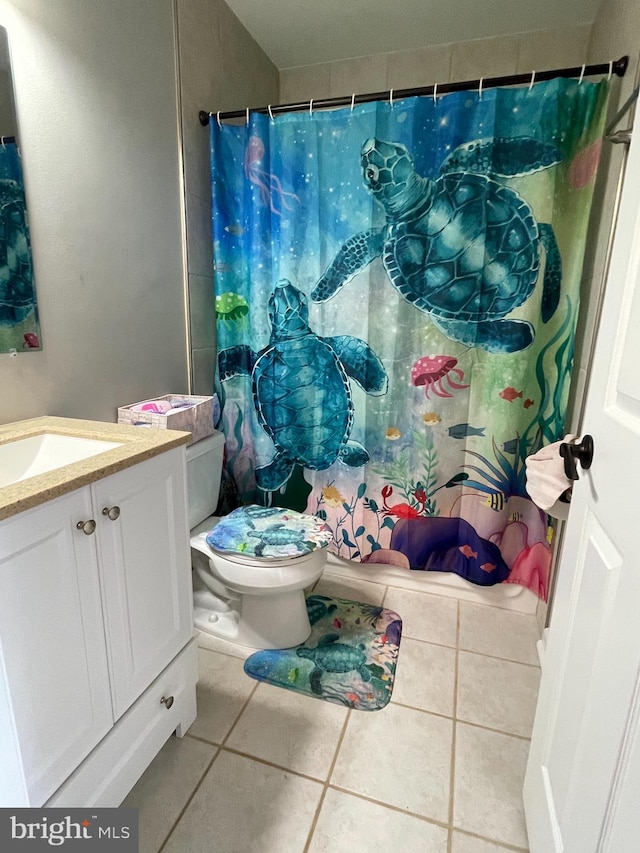 bathroom with tile patterned floors, curtained shower, vanity, and toilet