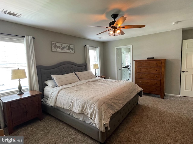 bedroom featuring ceiling fan, carpet, and ensuite bathroom