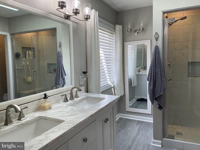 bathroom featuring an inviting chandelier, an enclosed shower, toilet, vanity, and hardwood / wood-style flooring