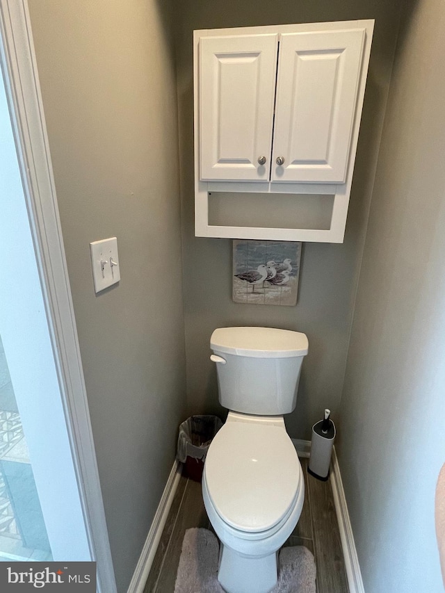 bathroom with toilet and hardwood / wood-style flooring