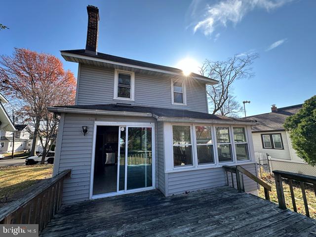 rear view of property with a wooden deck