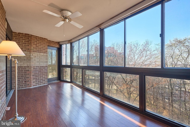 unfurnished sunroom featuring ceiling fan and a healthy amount of sunlight