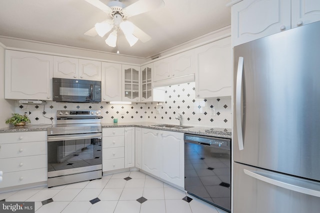 kitchen featuring backsplash, black appliances, sink, ceiling fan, and white cabinetry