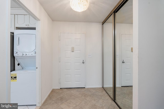 8370 Greensboro Dr Unit 414, Mclean, VA 22102 - laundry area featuring stacked washer and clothes dryer and baseboards