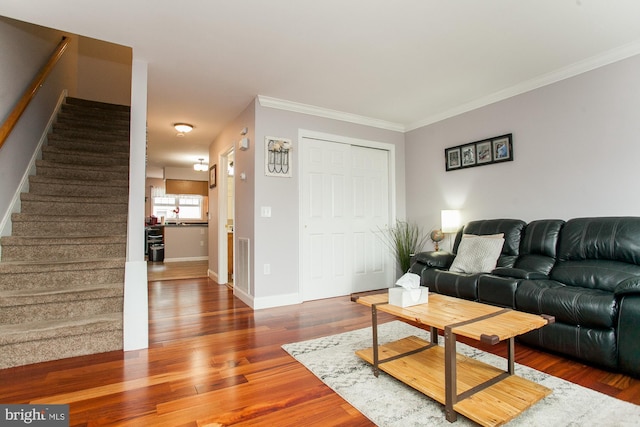 living room with hardwood / wood-style flooring and ornamental molding