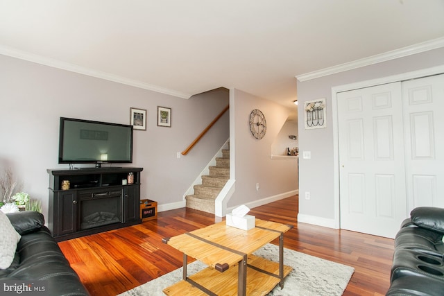 living room with hardwood / wood-style flooring and crown molding