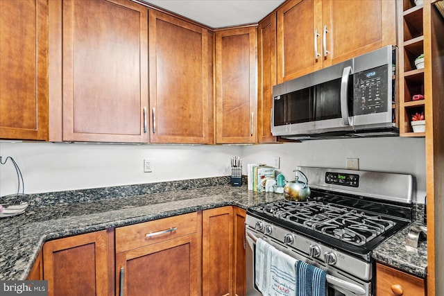 1830 Columbia Pike Unit 410, Arlington, VA 22204 - kitchen with appliances with stainless steel finishes, brown cabinetry, and dark stone counters
