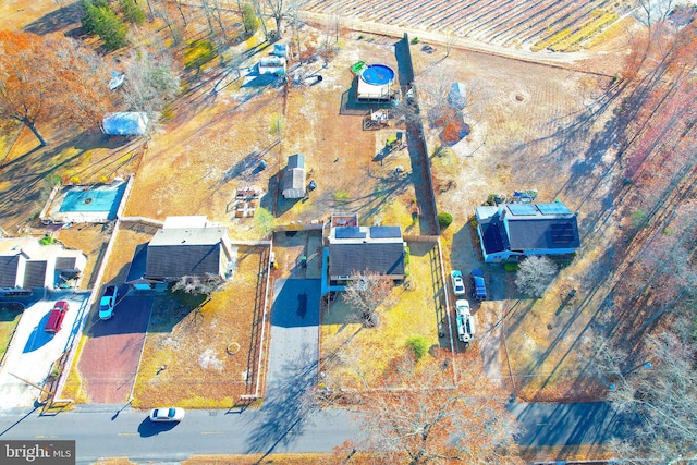 birds eye view of property with a rural view