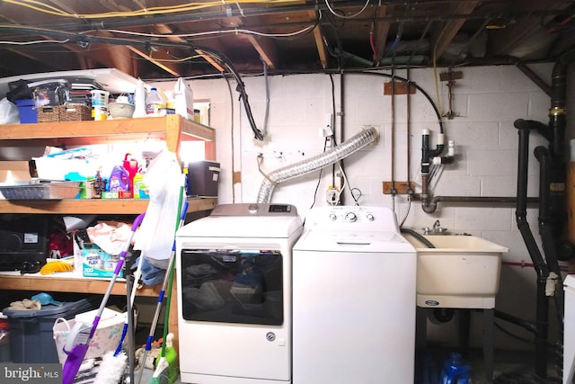 washroom with independent washer and dryer and sink