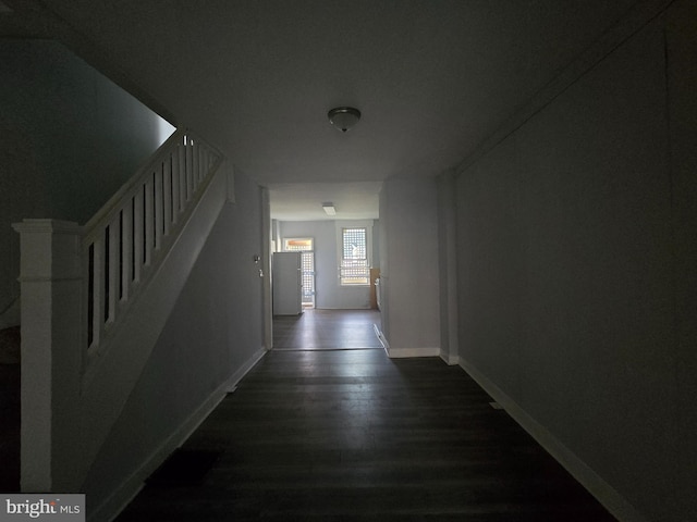 hall with dark wood-type flooring