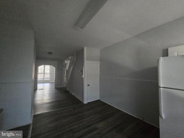 corridor featuring dark hardwood / wood-style flooring