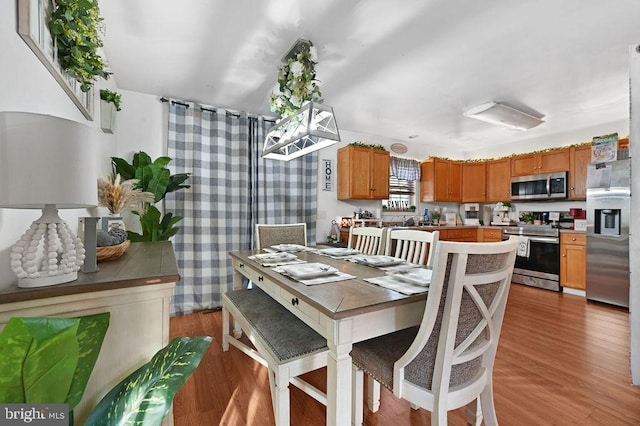 dining space with light hardwood / wood-style flooring