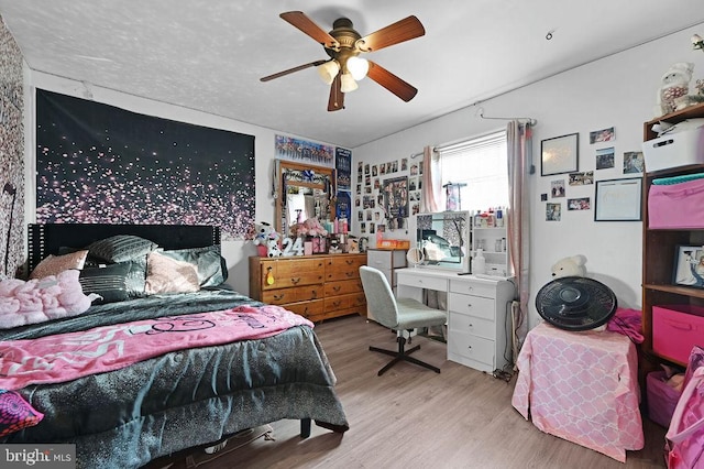 bedroom with light hardwood / wood-style floors and ceiling fan