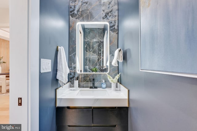 bathroom with hardwood / wood-style floors and vanity