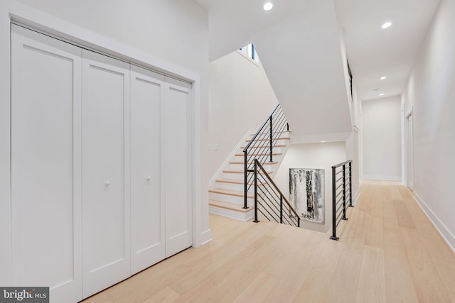 staircase with hardwood / wood-style flooring