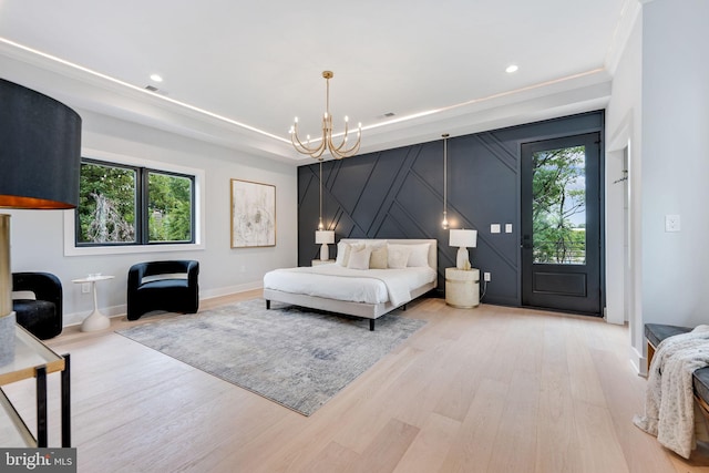 bedroom with multiple windows, an inviting chandelier, ornamental molding, and light wood-type flooring