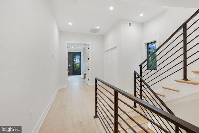 corridor with light hardwood / wood-style flooring