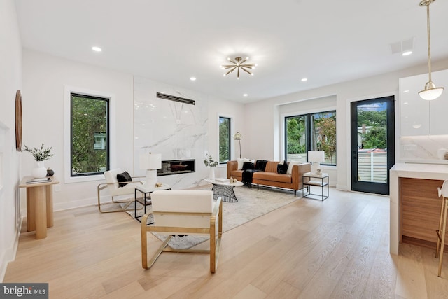 living room featuring a fireplace and light hardwood / wood-style flooring