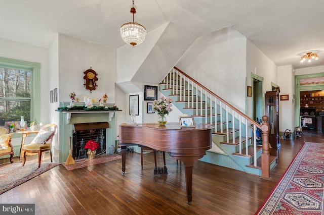 misc room with dark wood-type flooring and an inviting chandelier