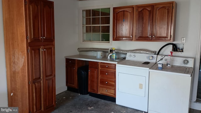 washroom with separate washer and dryer and cabinets