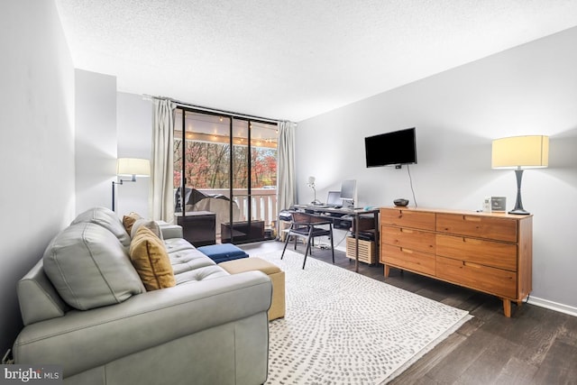 living room with a textured ceiling, expansive windows, and dark hardwood / wood-style floors