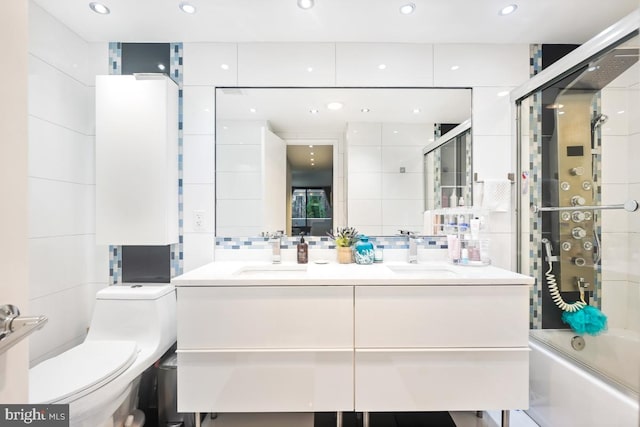 full bathroom with vanity, toilet, shower / bath combination with glass door, and decorative backsplash