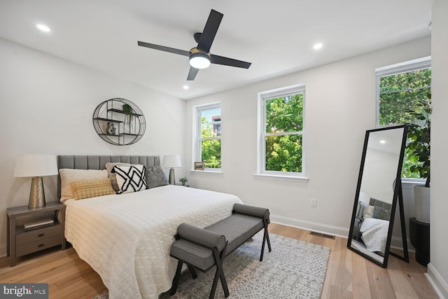 bedroom with ceiling fan and light hardwood / wood-style flooring