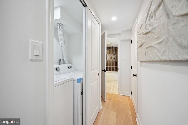 washroom featuring separate washer and dryer and light hardwood / wood-style flooring