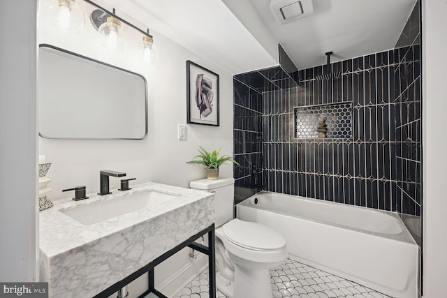 full bathroom featuring tile patterned floors, toilet, sink, and tiled shower / bath