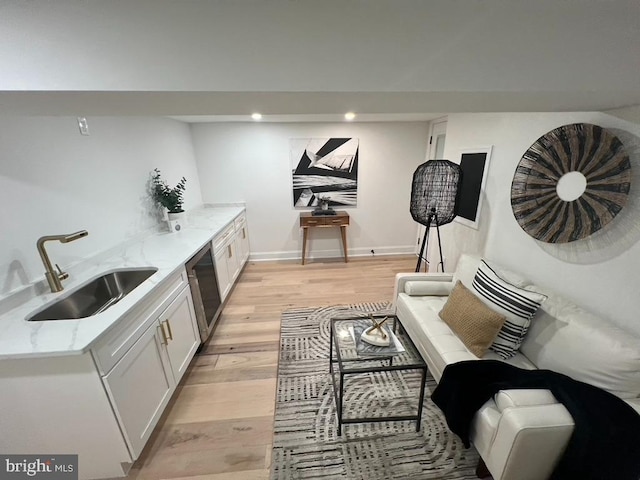 interior space featuring sink and light hardwood / wood-style flooring