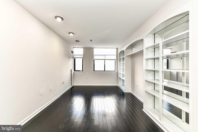 spare room featuring dark wood-type flooring