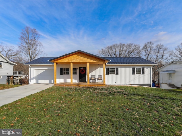 single story home with a porch, a front yard, and a garage