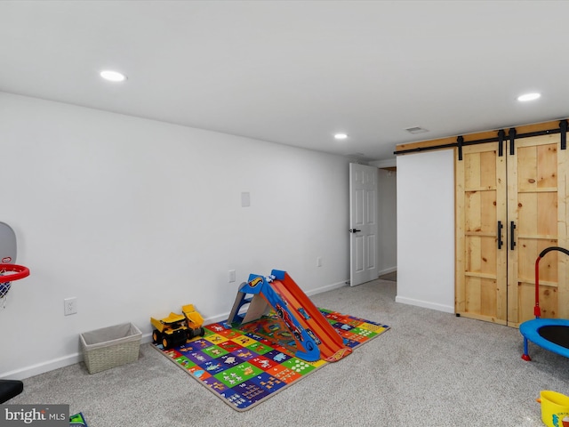 rec room featuring carpet flooring and a barn door